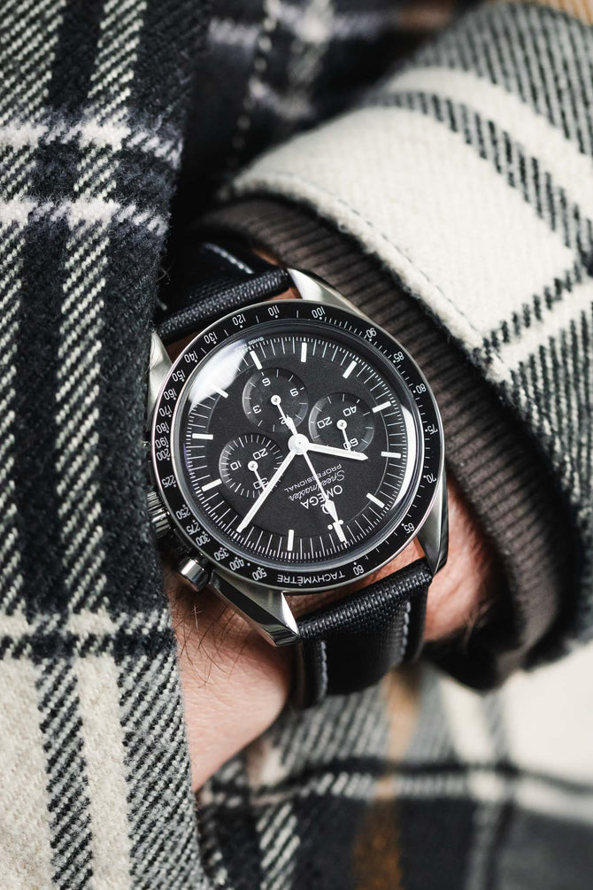 Black Omega Speedmaser Monnwatch fitted with Black Artem Straps sailcloth strap wuth grey stitching.