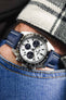 Navy Blue and white stitching Artem Straps Classic Sailcloth watch strap fitted to Seiko Panda chronograph speedtimer on wrist with hand in pocket of blue denim jeans and white and black flannel shirt.