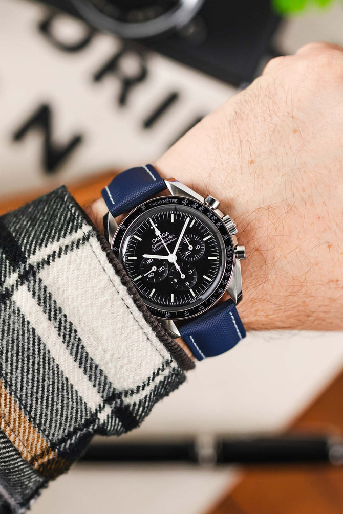 Navy Blue with white stitching Artem Loop-Less Sailcloth watch strap fitted to Black Omega Moonwatch Speedmaster and White and Black Flannel shirt