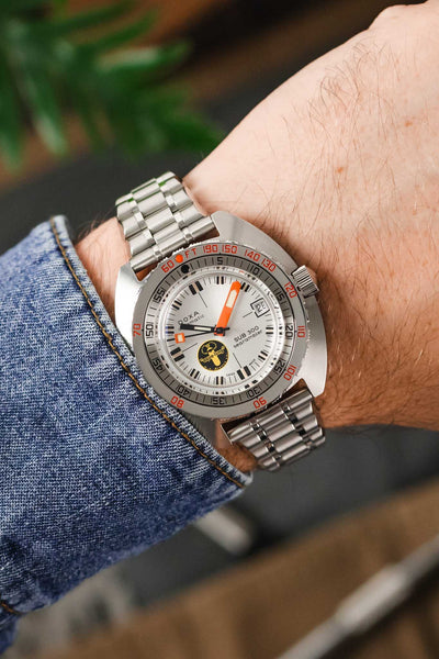 Photo of a wrist wearing a Doxa Sub 300 Watch with a Forstner Bullet watch bracelet