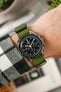 Omega Speedmaster fitted Green Nylon Watch Strap on wrist with check shirt