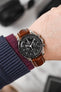 Black mega Speedmaster Moonwatch fitted with Hirsch Capitano Gold Brown leather strap worn on wrist