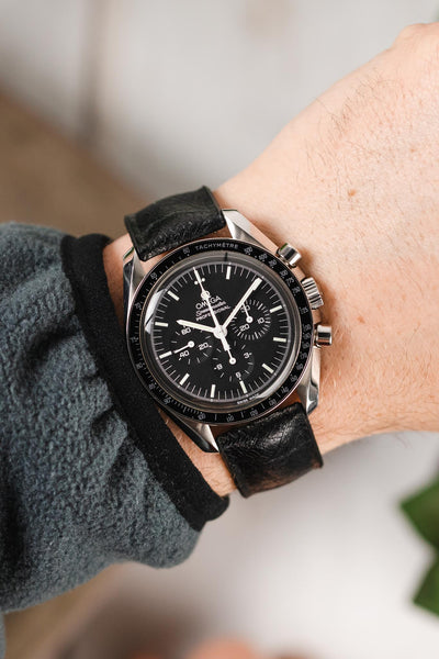 Black Omega Speedmaster Moonwatch fitted with Hirsch Leaf Vegan Rubber black watch strap worn on wrist