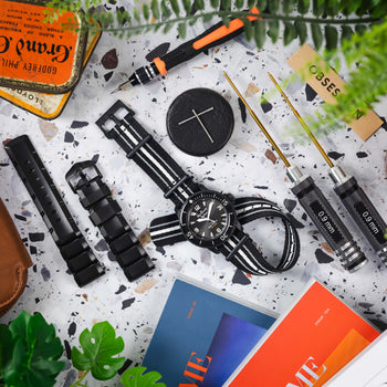 A top down photograph of a Blancpain Fifty Fathoms Ocean of Storms surrounded by tools and watch straps ready to be changed.