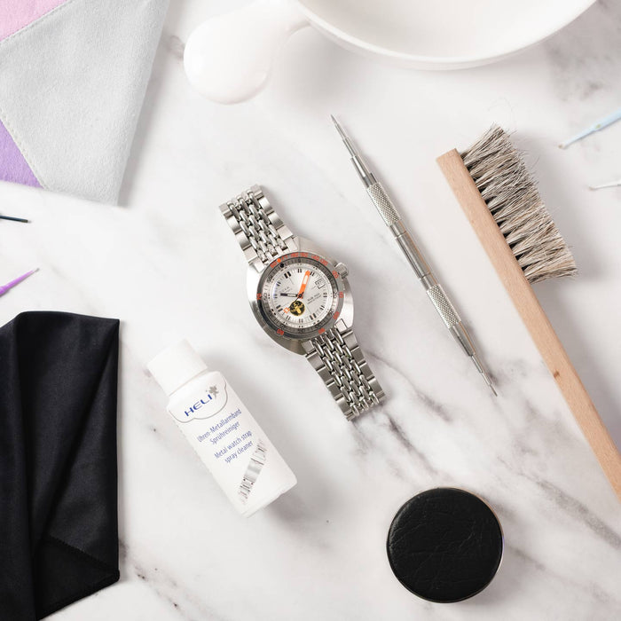 A Doxa Watch surrounded by tools and watch cleaning products