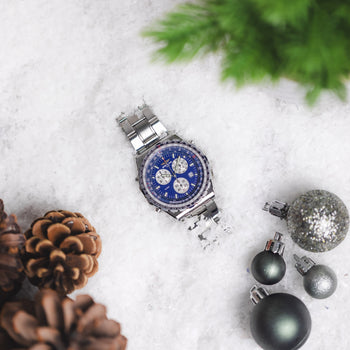 A Breitling Jupiter Pilot lay in the snow surrounded by Christmas tree foliage, baubles and pine cones