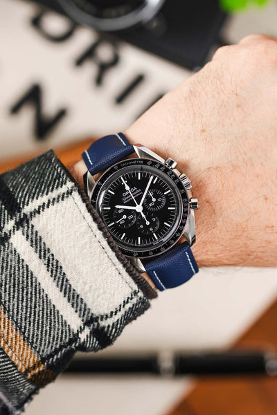 Navy Blue with white stitching Artem Loop-Less Sailcloth watch strap fitted to Black Omega Moonwatch Speedmaster and White and Black Flannel shirt