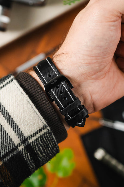 Artem Straps RM style deployment clasp in PVD black with embossed logo fitted to Artem Straps classic sailcloth watch strap worn on wrist with flannel shirt