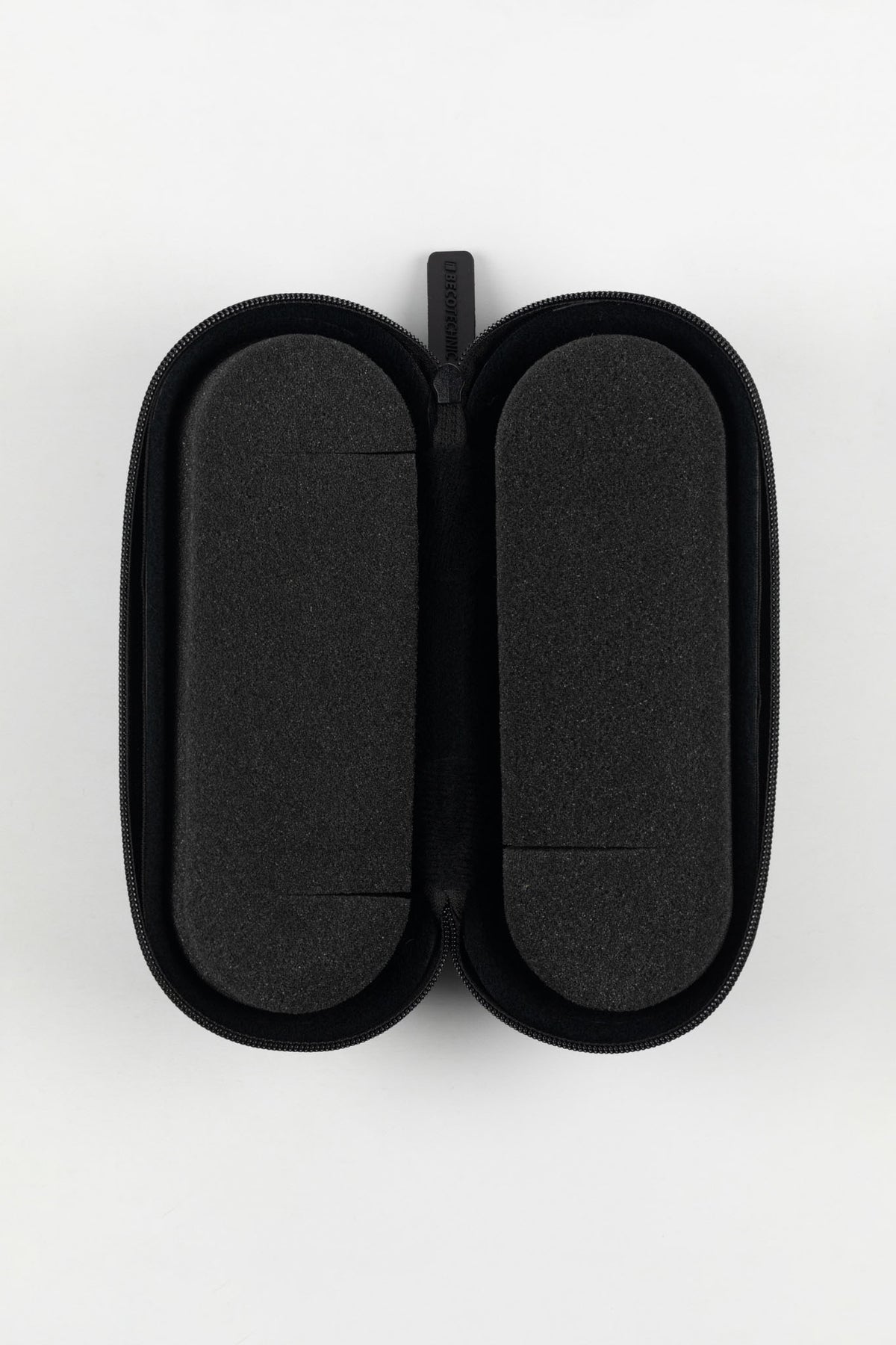 Open black hard-shell watch case with dual removable foam inserts and a soft protective interior, designed to securely store and protect a wristwatch during travel.