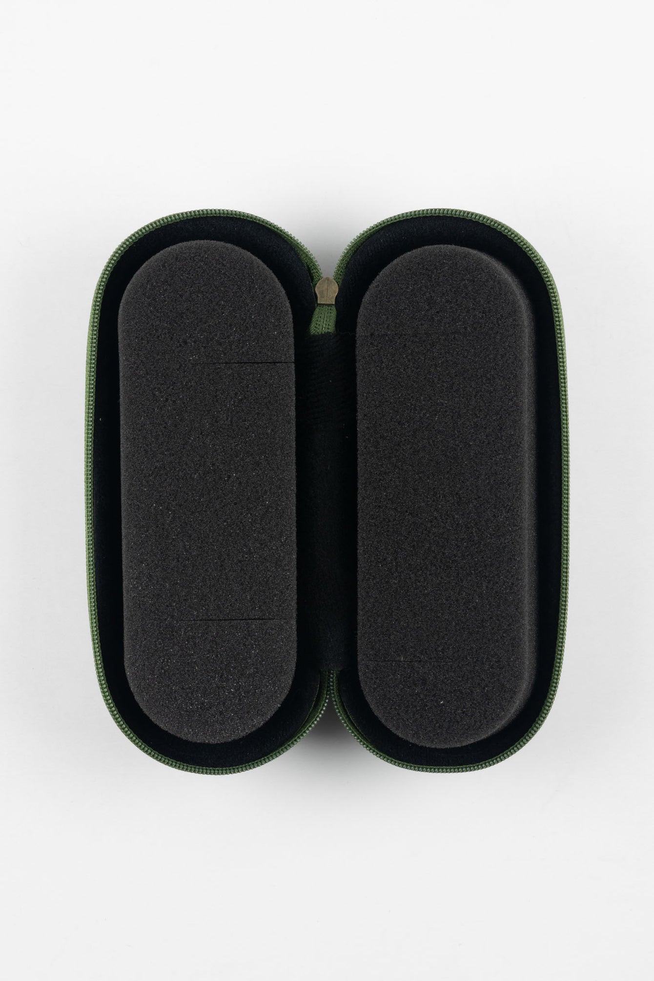 Open green zippered case with a soft black foam interior, holding two long, oval-shaped padded compartments, displayed on a plain light background.