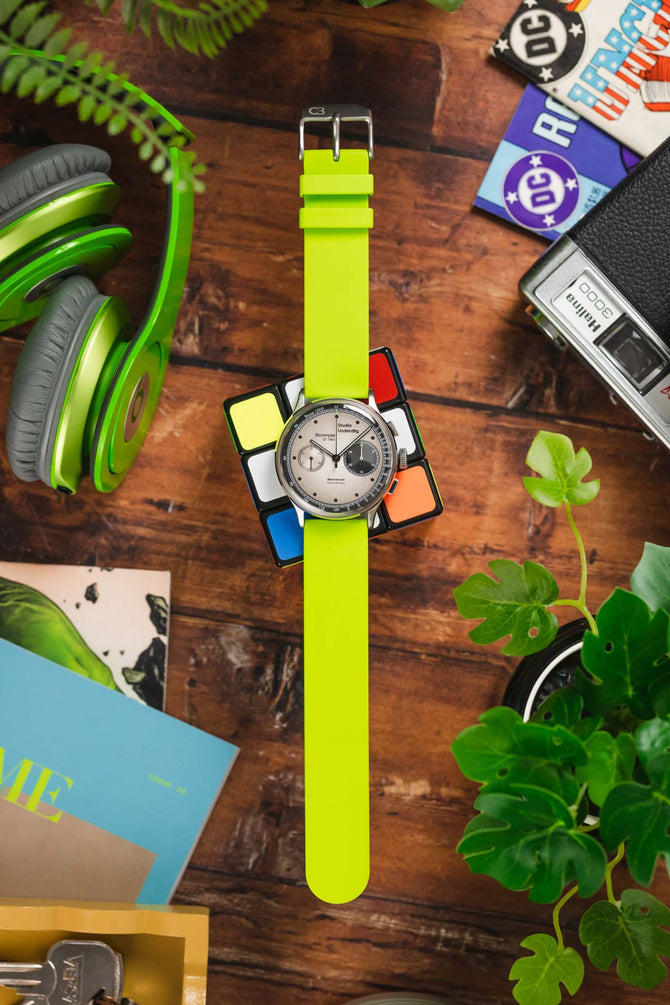 Studio Underd0g Go0fy Panda watch with Bonetto Cinturini 270 Lime Green watch strap flat on wooden table