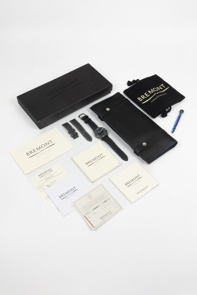All box and papers included in the sale of the Bremont Boeing Watch showing Chronometer certificate, warranty card, instructions, lug tool, travel case and outer box.