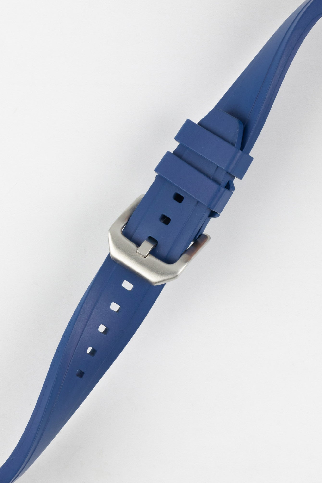 Crafter Blue watch strap done up with brushed silver stainless steel buckle twisted to show flexibility and comfort