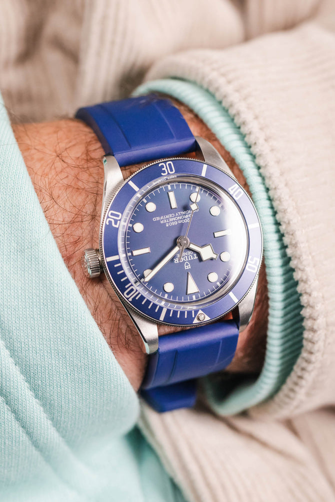 Pocket shot of a Tudor BB58 in the pocket of a turquoise hoodie and cream cord shirt, the watch is fitted to a Blue rubber strap