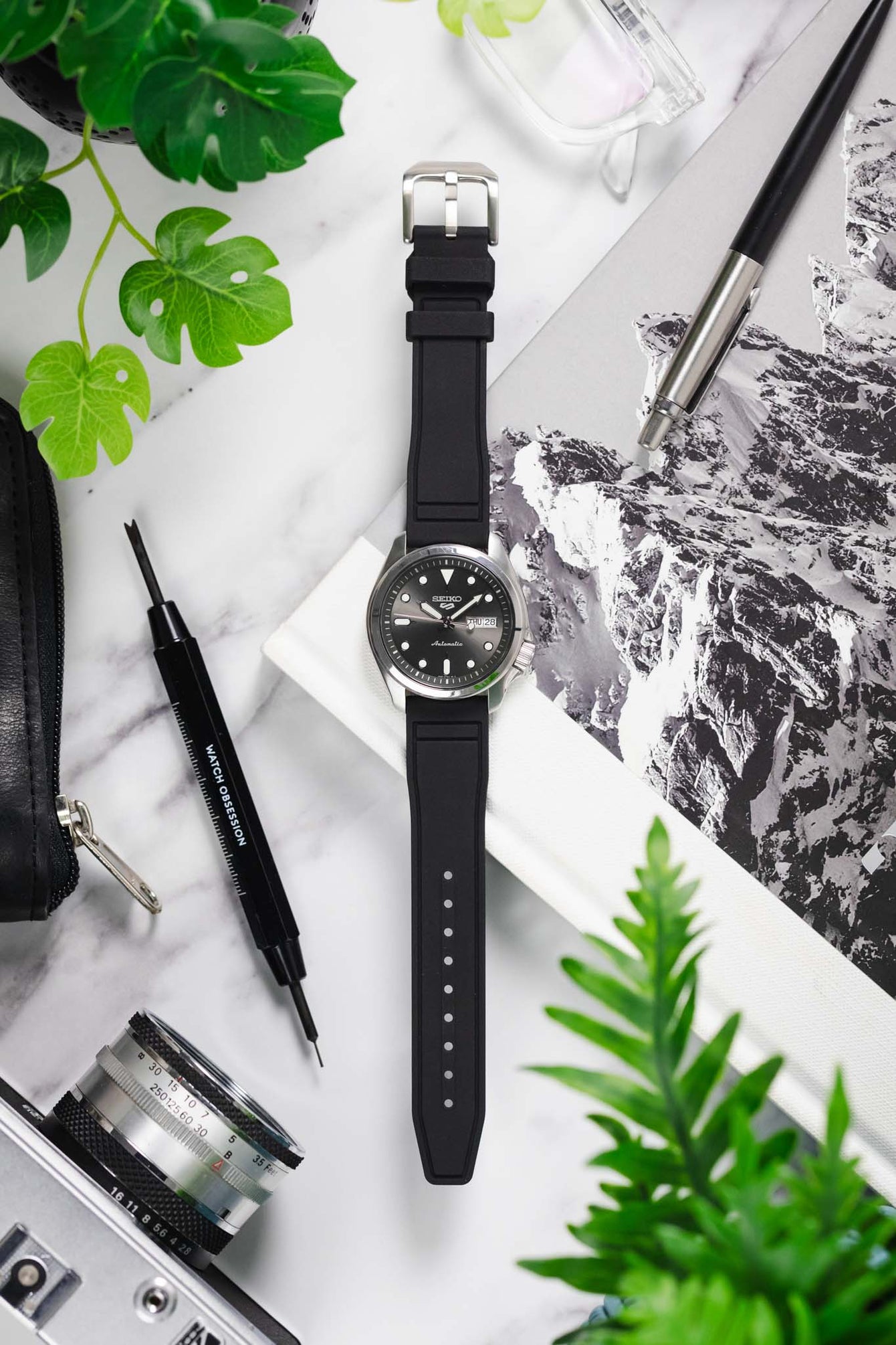 Seiko 5 sports anthracite dial srpe51k1 fitted with crafter blue ux07 rubber strap in black with brushed stainless steel buckle layed flat