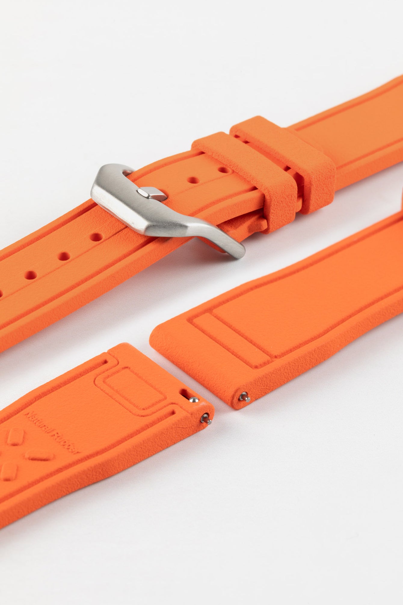 Product photo on the UX07 Rubber FKM Pilots strap showing the buckle done up in brushed steel, next to the underside of the strap showing the quick release spring bar