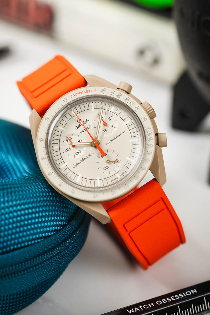 Omega Speedmaster Moonswatch Jupiter with orange strap combo to match the chronograph hand
