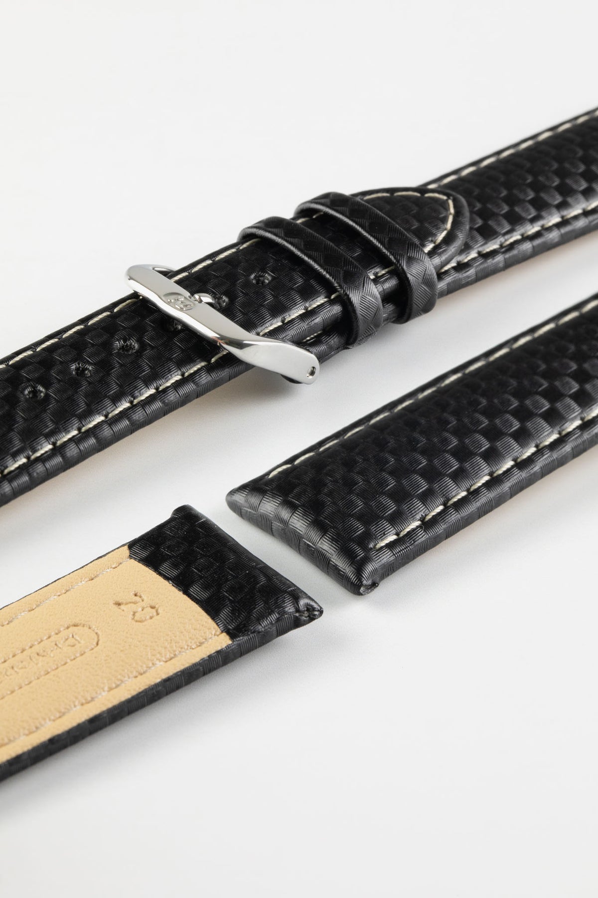 Black carbon-fibre-pattern leather watch strap with beige contrast stitching, a polished stainless steel buckle, and beige leather lining, displayed on a white background.