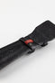 Close-up of the underside of a black padded leather rally-style watch strap, featuring a smooth black leather lining, embossed branding, dual black keeper loops, a red woven accent keeper, and reinforced lug-end padding, displayed on a light grey background to highlight the premium construction, contrasting red detailing, and motorsport-inspired design.