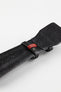 Close-up of the underside of a dark brown padded leather rally-style watch strap, featuring a black textured leather lining with embossed branding, dual black leather keeper loops, a distinctive red woven accent keeper, and reinforced lug-end padding, displayed on a light grey background to highlight the premium handcrafted construction, contrasting details, and vintage motorsport-inspired design.
