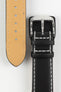 Black leather watch strap with white contrast stitching, beige leather lining, and a polished stainless steel buckle, displayed on a white background.