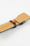 Black leather watch strap with a beige perforated leather lining, white stitching, and a polished stainless steel buckle, shown in close-up on a white background.