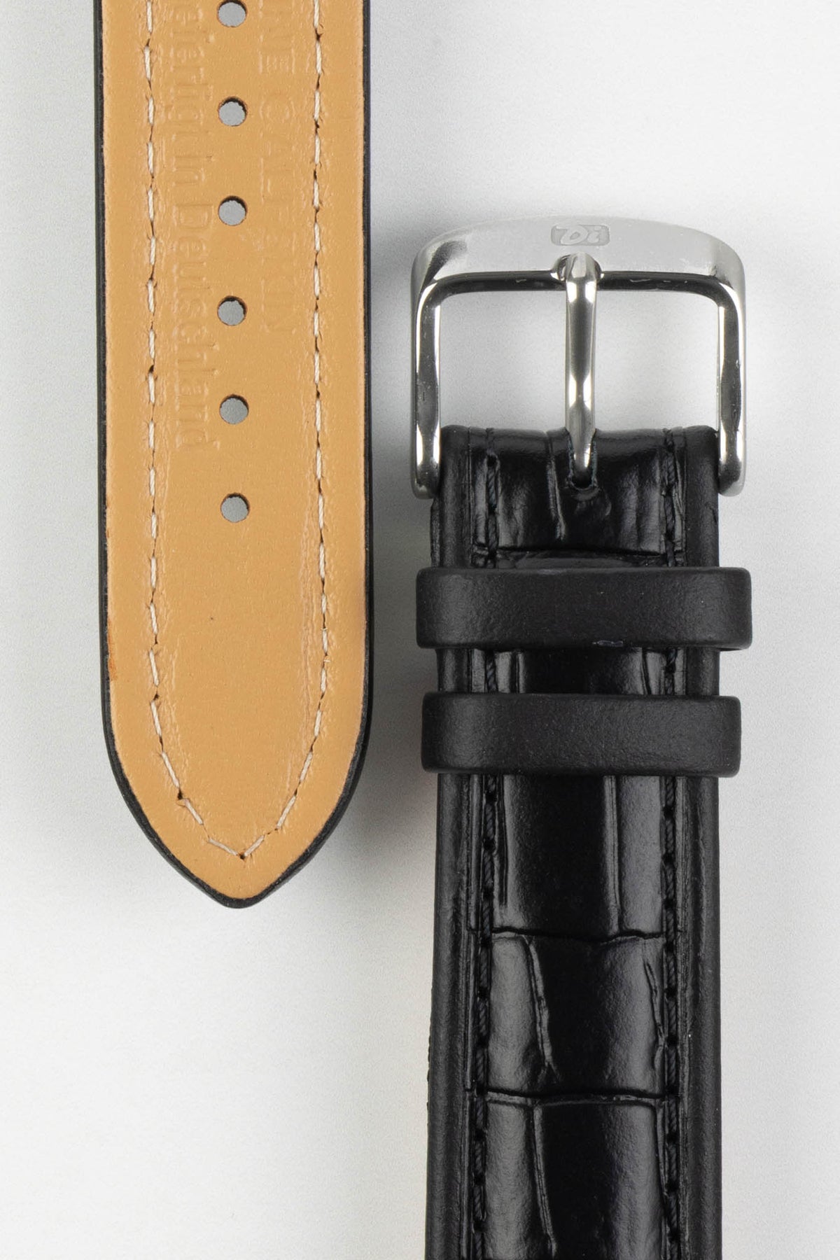 Black alligator-grain leather watch strap with a beige leather lining, matching black stitching, and a polished stainless steel buckle, displayed on a white background.