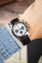 Seiko Speedtimer chronograph on a black alligator-grain leather strap, shown on wrist with a white panda dial and black tachymeter bezel.