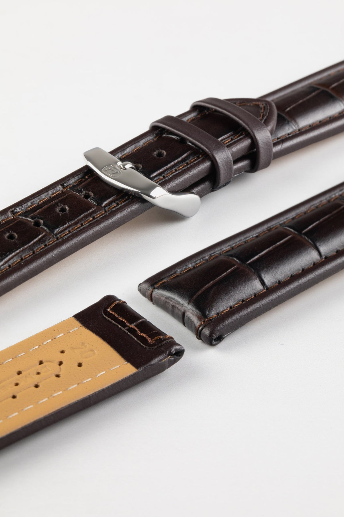Dark brown alligator-grain leather watch strap with a polished stainless steel buckle and embossed crocodile pattern, displayed on a white background.