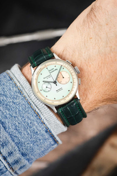 Studio Underd0g Bicompax chronograph watch on a dark green alligator-grain leather strap, shown on wrist with a mint-green dial and polished stainless steel case.
