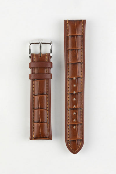 Brown alligator-grain leather watch strap with matching brown stitching and a polished stainless steel buckle, displayed on a white background.