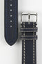 Navy blue leather watch strap with cream contrast stitching, navy leather lining, and a polished stainless steel buckle, displayed on a white background.