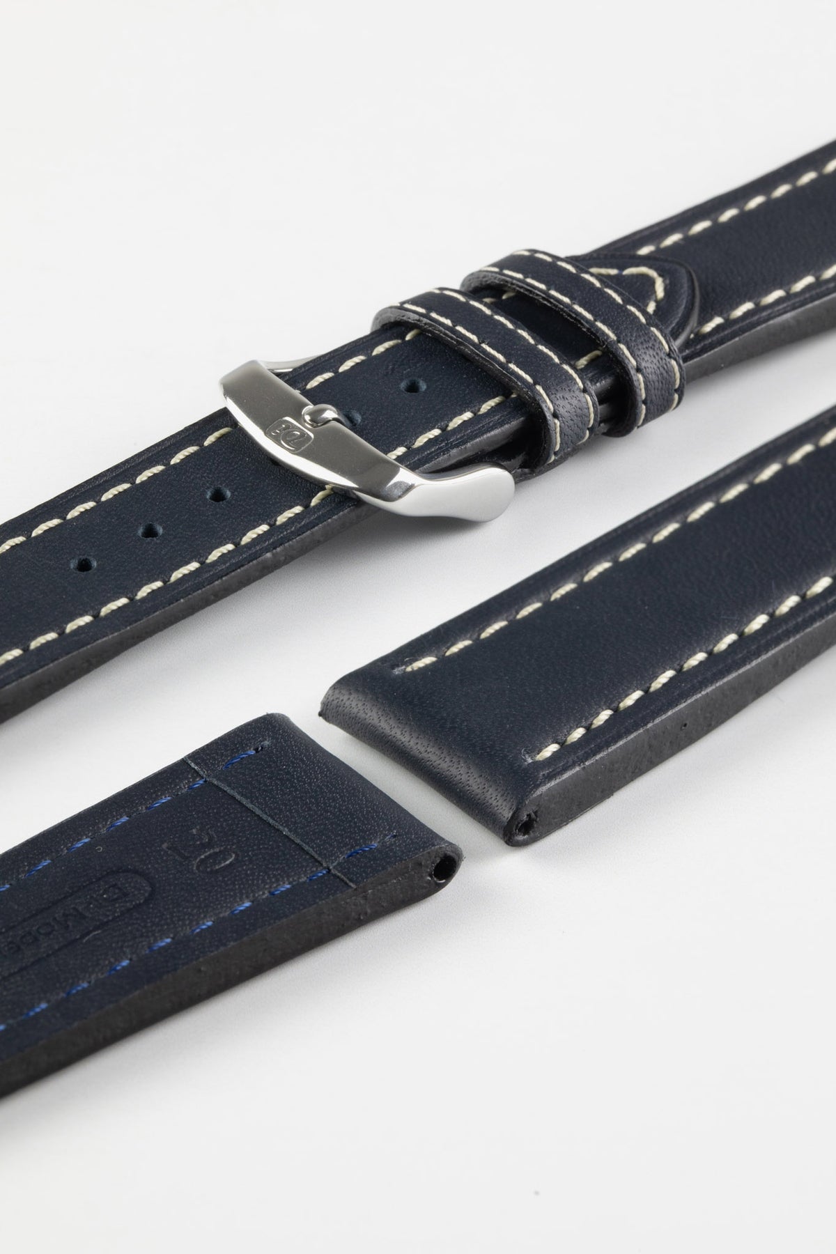 Navy blue leather watch strap with cream contrast stitching and a polished stainless steel buckle, displayed on a white background.