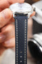Navy blue leather watch strap fitted to a Seiko Presage automatic watch, highlighting the cream contrast stitching and smooth leather finish.