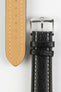 Black vintage-style leather rally watch strap with cream contrast stitching, beige leather lining, and a polished stainless steel buckle, displayed on a white background.