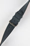 Close-up of a dark navy nubuck leather watch strap with a soft matte finish, tonal stitching, dual keeper loops, multiple adjustment holes, and a brushed stainless steel buckle, displayed diagonally on a light grey background to highlight the tapered profile, supple suede-like texture, and premium handcrafted construction.