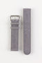Two-piece light grey nubuck leather watch strap with a soft matte finish, tonal grey stitching, rounded tip, multiple adjustment holes, dual keeper loops, and a brushed stainless steel buckle, displayed flat on a light grey background to showcase the subtle suede-like texture, minimalist design, and premium handcrafted construction.