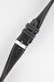 Close-up of a black leather watch strap with a smooth matte finish, contrasting cream stitching, tapered pointed tip, dual keeper loops, multiple adjustment holes, and a polished stainless steel buckle, displayed diagonally on a light grey background to highlight the vintage-inspired design, premium handcrafted construction, and refined leather detailing.