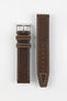 Two-piece dark brown leather watch strap with a smooth matte finish, contrasting cream stitching, tapered profile, pointed tip, multiple adjustment holes, dual keeper loops, and a polished stainless steel buckle, displayed flat on a light grey background to showcase the rich leather tone, vintage-inspired design, and premium handcrafted construction.