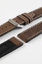 Close-up detail view of a dark brown leather watch strap displayed with one strap section detached, featuring a smooth vintage-style finish, cream contrast stitching, dual keeper loops, multiple adjustment holes, a polished stainless steel buckle, and a black leather lining embossed with the Di-Modell logo and size marking, shown on a light grey background to highlight the premium handcrafted construction, tapered profile, and quick-release spring bar compatibility.
