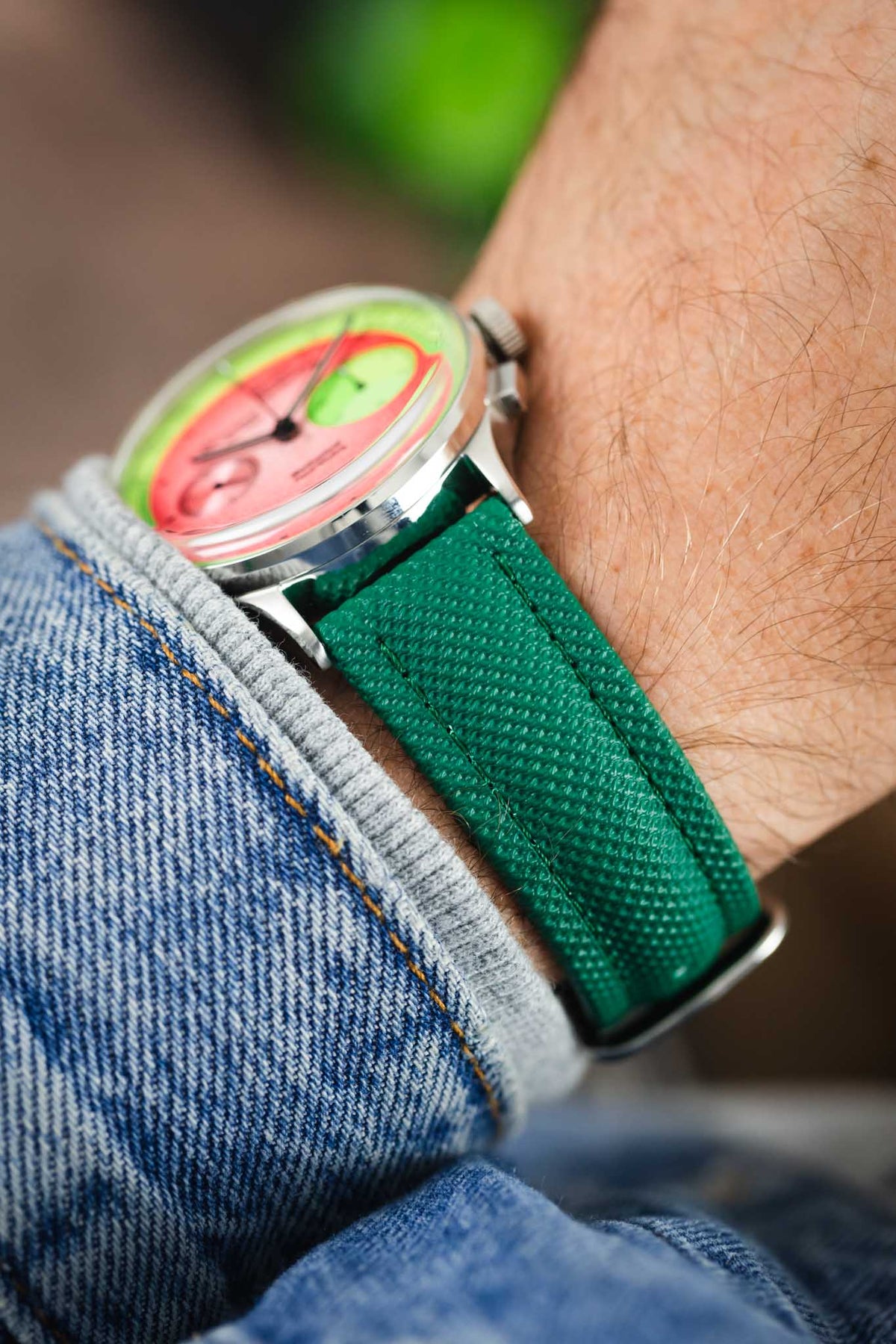 Studio Underd0g chronograph watch on a green textured leather strap, highlighting the embossed grain texture and vibrant green colour in an on-wrist close-up.