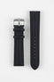 Black Di-Modell Traveller leather watch strap displayed in two separate pieces on a white background. Features a textured leather finish, polished stainless steel buckle, matching black keepers, tonal stitching, multiple adjustment holes, and a rounded tip for a classic, understated look.