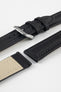 Close-up of a black Di-Modell Traveller leather watch strap shown in separate pieces on a white background. Features a textured leather finish, polished stainless steel buckle, matching black keepers, tonal stitching, quick-release spring bars, and a beige leather-lined underside.