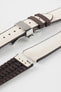 Beige textile-effect watch strap with brown rubber backing and a silver-tone deployment clasp, shown in separate sections on a white background. Features a woven-look surface, brown edges, and a patterned rubber underside.