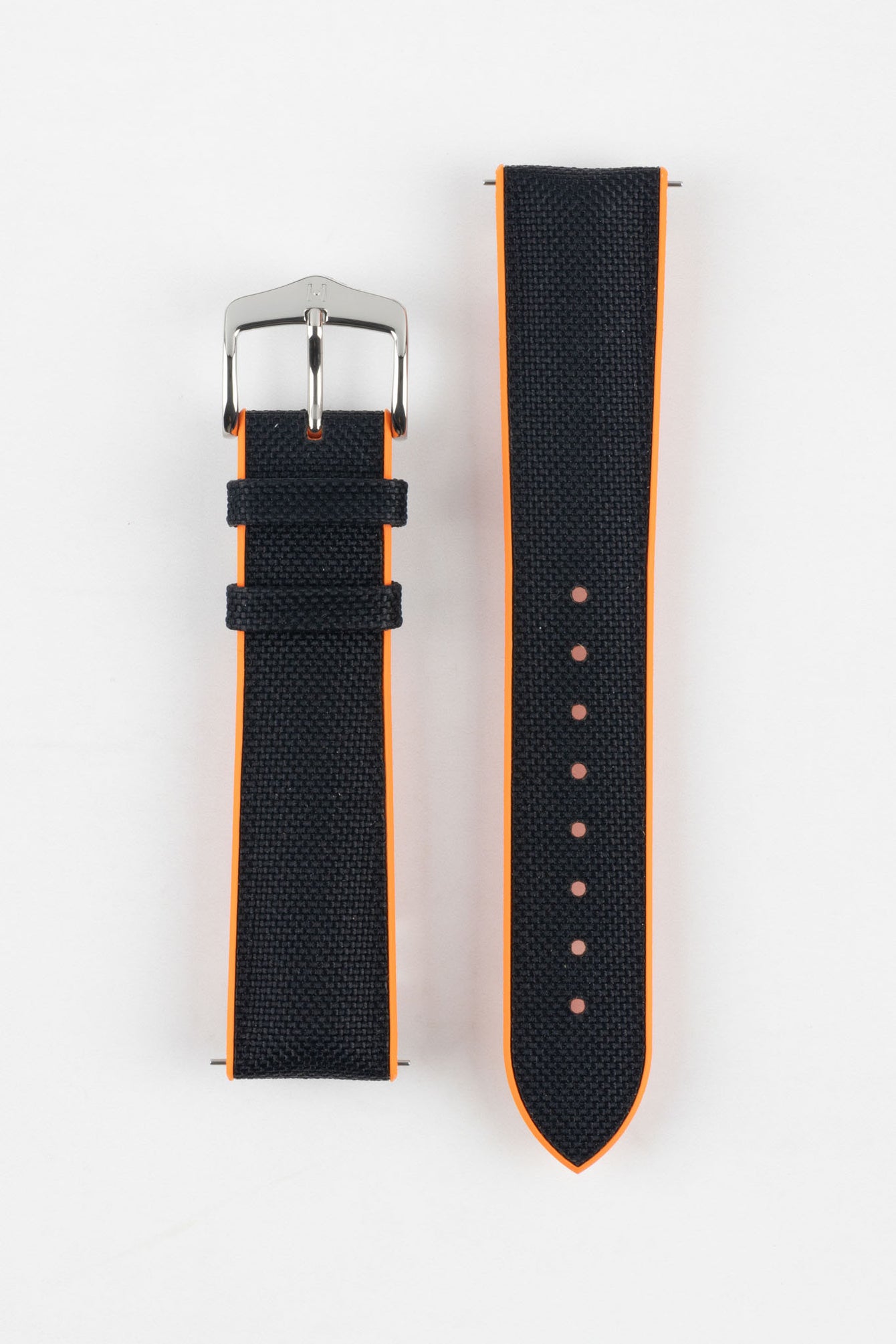 Black textile-effect watch strap with bright orange rubber backing, displayed in two separate pieces on a white background. Features a silver-tone buckle, textured woven-look surface, orange edges, and multiple adjustment holes.