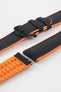 Black textile-effect watch strap with bright orange rubber backing and a black buckle, shown in separate sections on a white background. Features a textured woven-look surface, orange edges, and a patterned rubber underside.