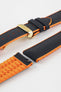 Black textile-effect watch strap with bright orange rubber backing and a gold-tone folding clasp, shown in separate sections on a white background. Features a textured woven-look surface, orange edges, and a patterned rubber underside.