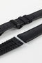 A detailed, slightly angled shot of a black Hirsch Arne Performance Watch Strap, laid in two pieces on a white background, highlighting its woven black upper, black ribbed underside, and a black clasp.