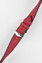 A diagonal close-up of a burgundy Hirsch Arne Performance watch strap with a polished silver buckle, set against a bright white background. The textured surface of the red strap and the black lining are clearly visible.