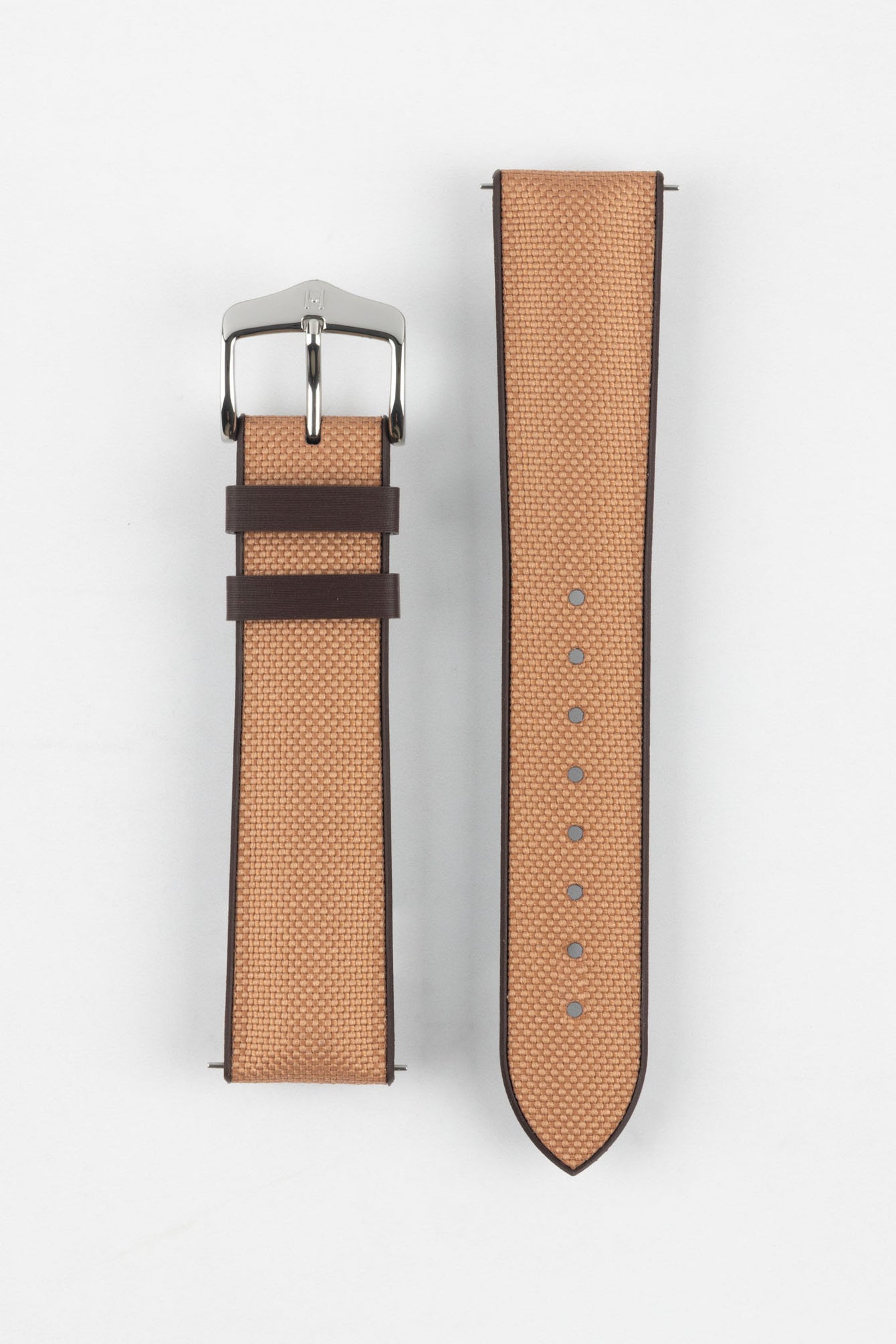 Golden brown textile-effect watch strap with a silver-tone buckle, displayed in two separate pieces on a white background. Features brown edges, a woven-look texture, and multiple adjustment holes.